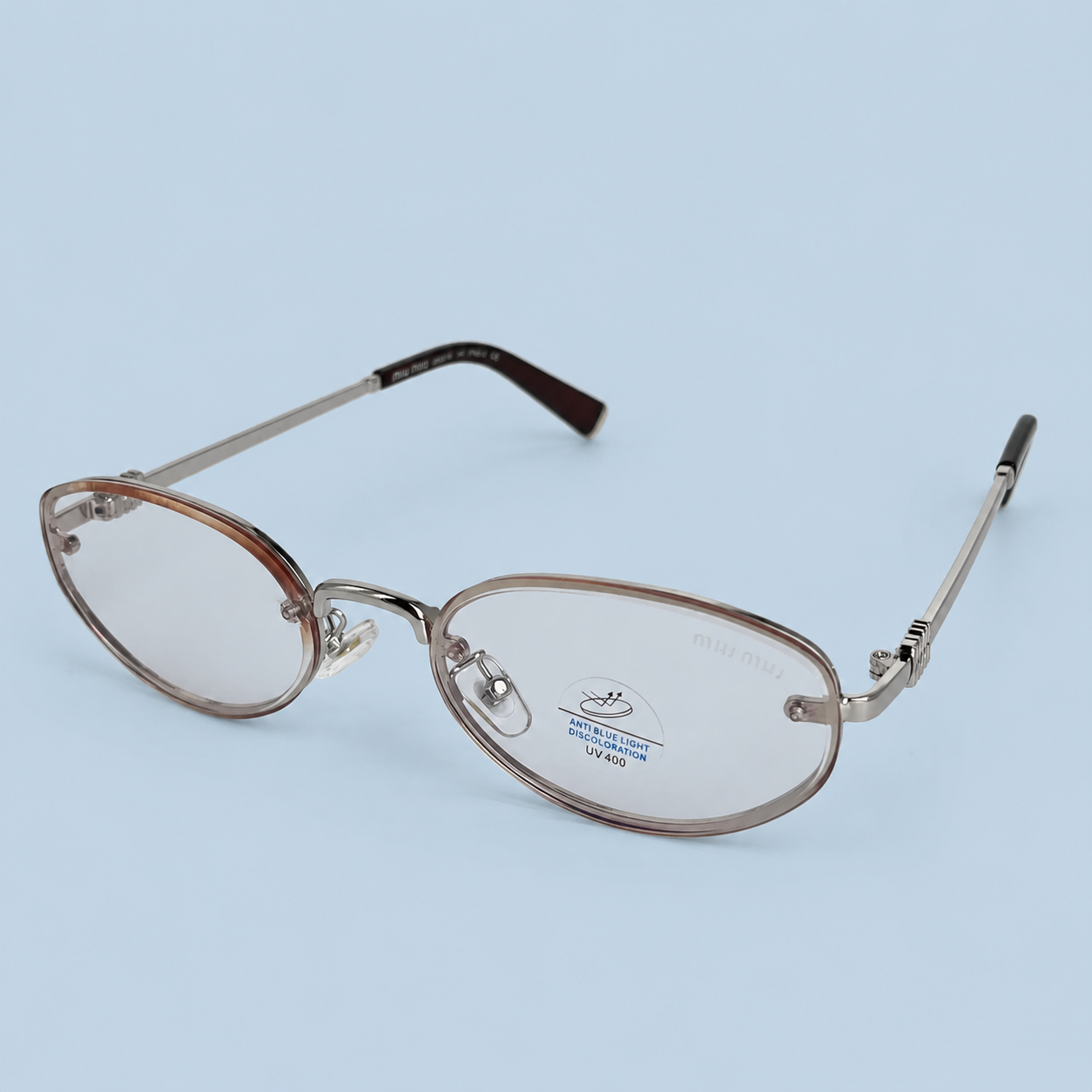 MIU MIU — Monture Ovale Sans Cerclage, Métal Argenté, Verres Clairs
